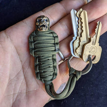 Load image into Gallery viewer, Paracord Keychain Mummy Brass Skull